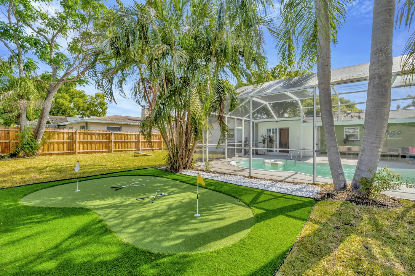 Mini putting green beside the screened pool
